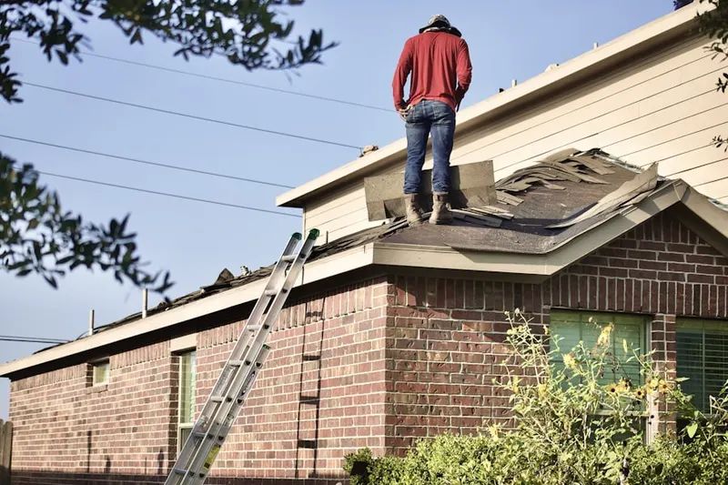Professional roofer working on a residential roof in Allegiance